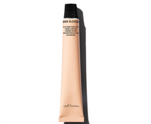 Tube of hand cream with 'The Alchemist' branding on a white background