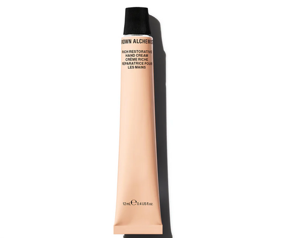 Tube of hand cream with 'The Alchemist' branding on a white background
