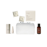 Collection of skincare products including a bag, bottles, and packets on a white background