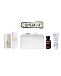 Collection of toiletries including a Marvis toothpaste tube on a white background