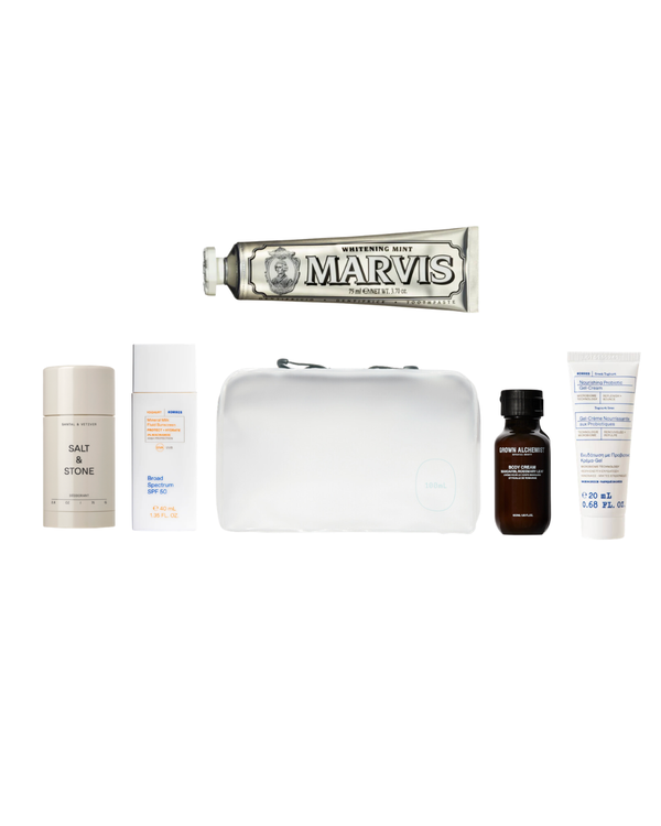 Collection of toiletries including a Marvis toothpaste tube on a white background